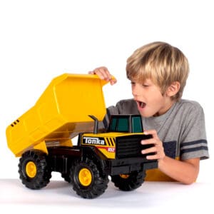 Boy Smiling with Mighty Dump Truck