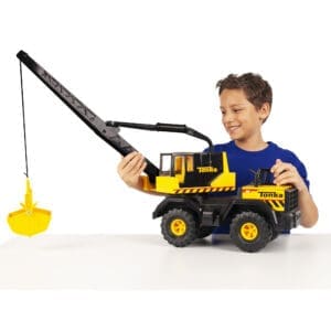 Kid with Tonka Mighty Crane against white background.