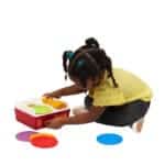 Young girl playing with Fisher-Price Record Player.
