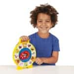 Young boy playing with Fisher-Price Classics See N Say.