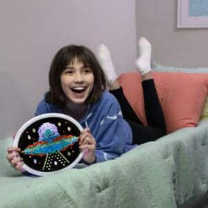 Young girl smiling with Oval HD Lite Brite.