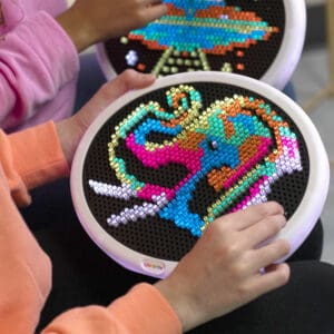 Hand playing with Oval Lite Brite