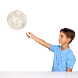 Young boy using Uncle Miltons Moon In My Room