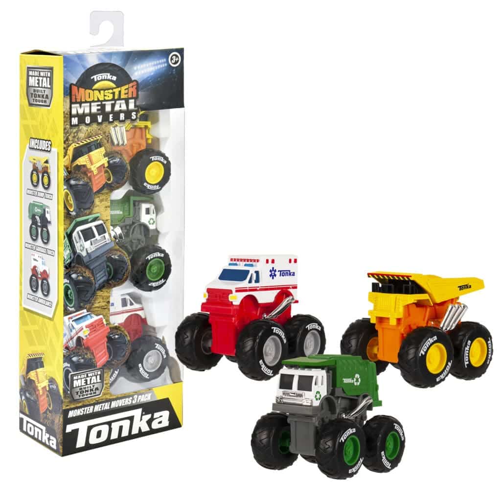 3 Monster Metal Movers next to their box on white background