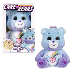 A blue Dream Bright Bear plush toy from the Care Bears collection is shown against a plain white background. The toy features a heart-shaped shooting star on its belly and has a cheerful, smiling expression.