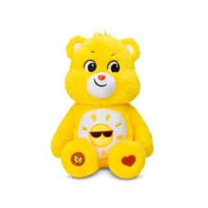 A yellow Funshine Bear plush toy from the Care Bears collection is shown against a plain white background. The toy features a smiling sun on its belly and has a cheerful expression.