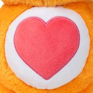 Close up of Tenderheart bear's stomach with pink heart patch.