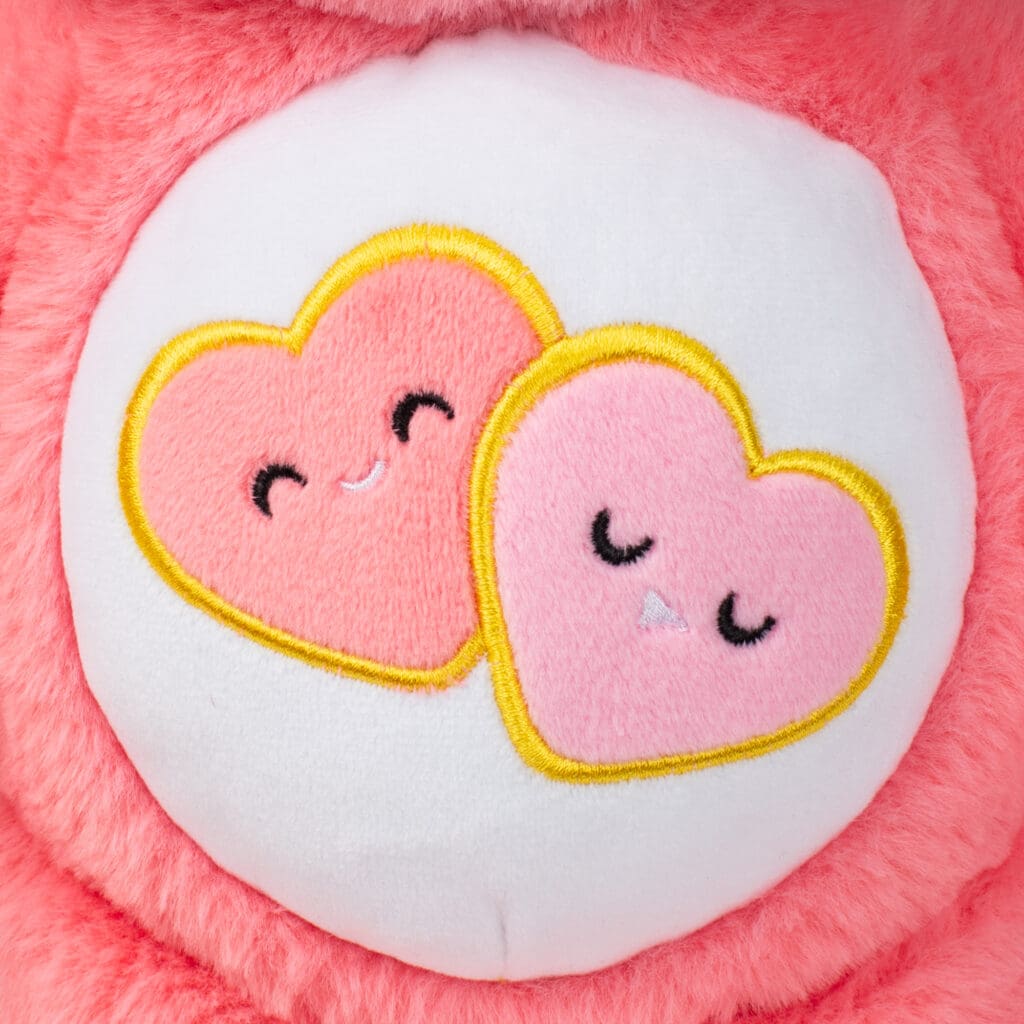 Close up of Love-A-Lot Bear's Belly, emphasizing the emblem with two pink heats.