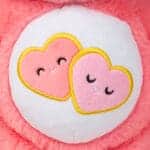 Close up of Love-A-Lot Bear's Belly, emphasizing the emblem with two pink heats.