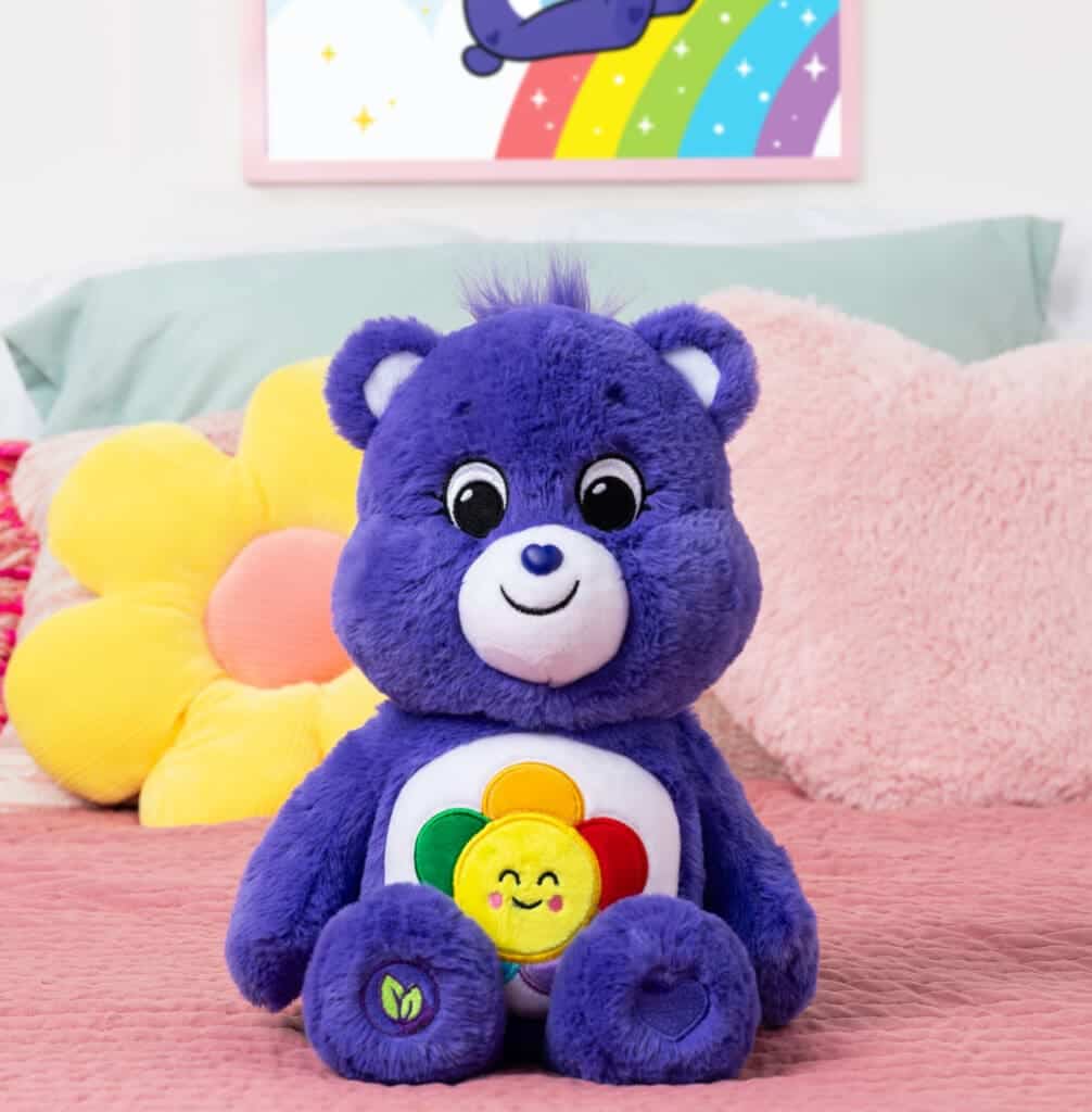 Violet Harmony Bear on bed.