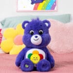 Violet Harmony Bear on bed.