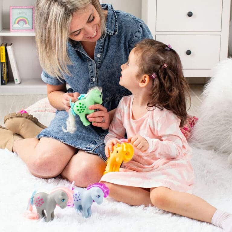 Mother and Daughter brushing ponies' hair.