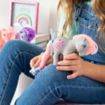 Close up of My Little Pony tale being brushed by young girl.