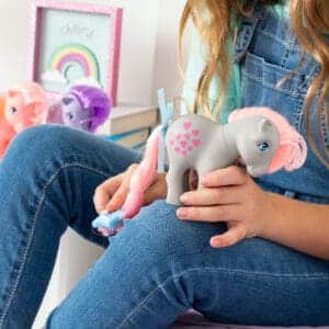 Close up of My Little Pony tale being brushed by young girl.