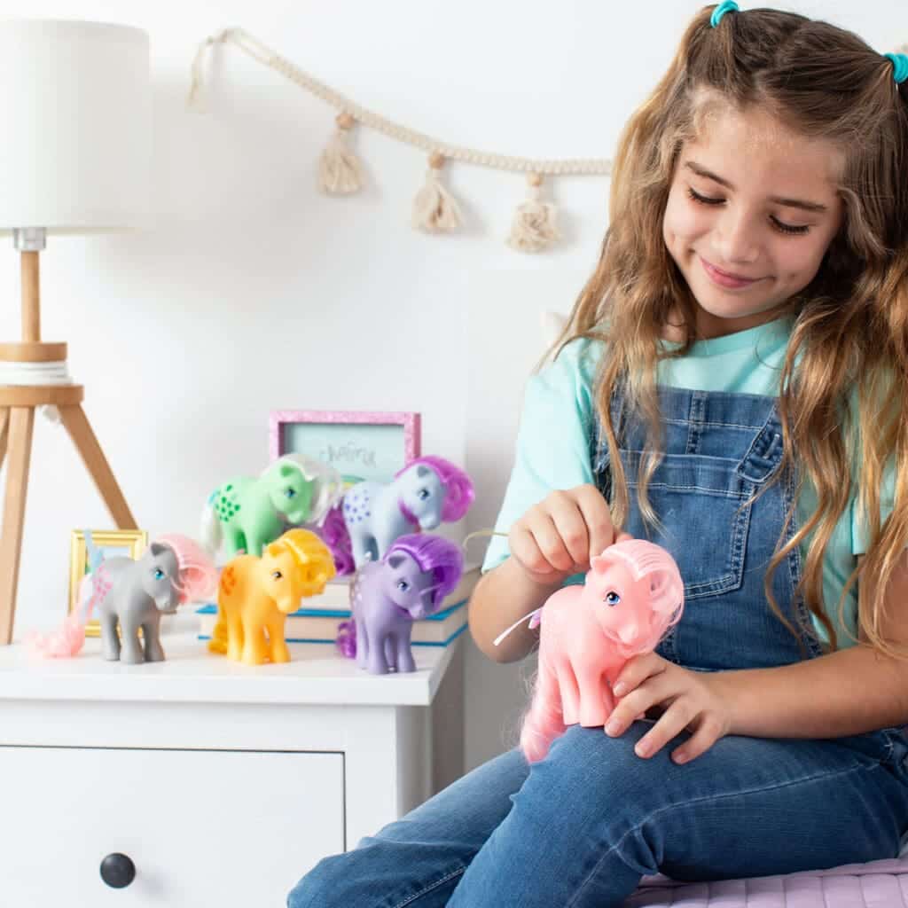 Young girl with My Little Pony Collection in bedroom.