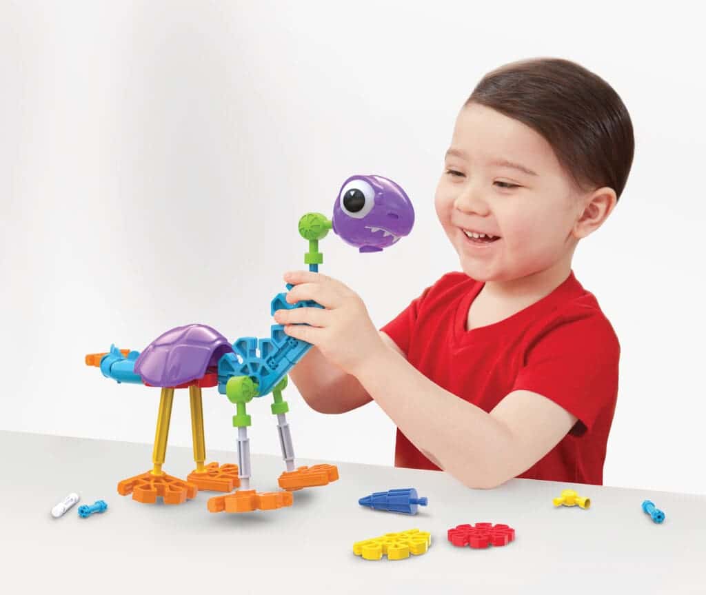 Young boy playing with K'nex Dino Dudes Building Set.