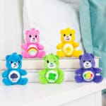 Assortment of five Care Bear Micro Plush bears on table.