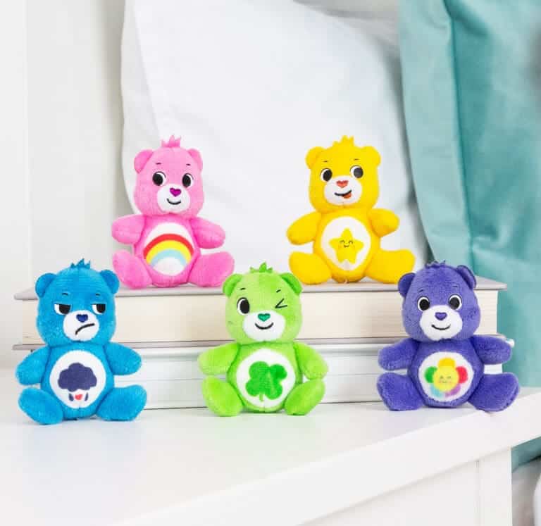 Assortment of five Care Bear Micro Plush bears on table.