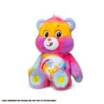 A purple Dare to Care Bear plush toy from the Care Bears collection is shown against a plain white background. The toy features two intertwined stars on its belly and has a cheerful expression.