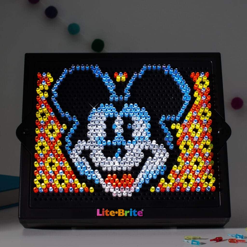 Lite Brite Disney 100 HD lit up on desk.