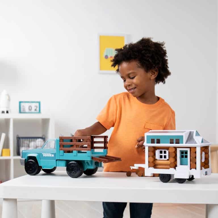 Kid with Lincoln Logs Tonka Tiny Home