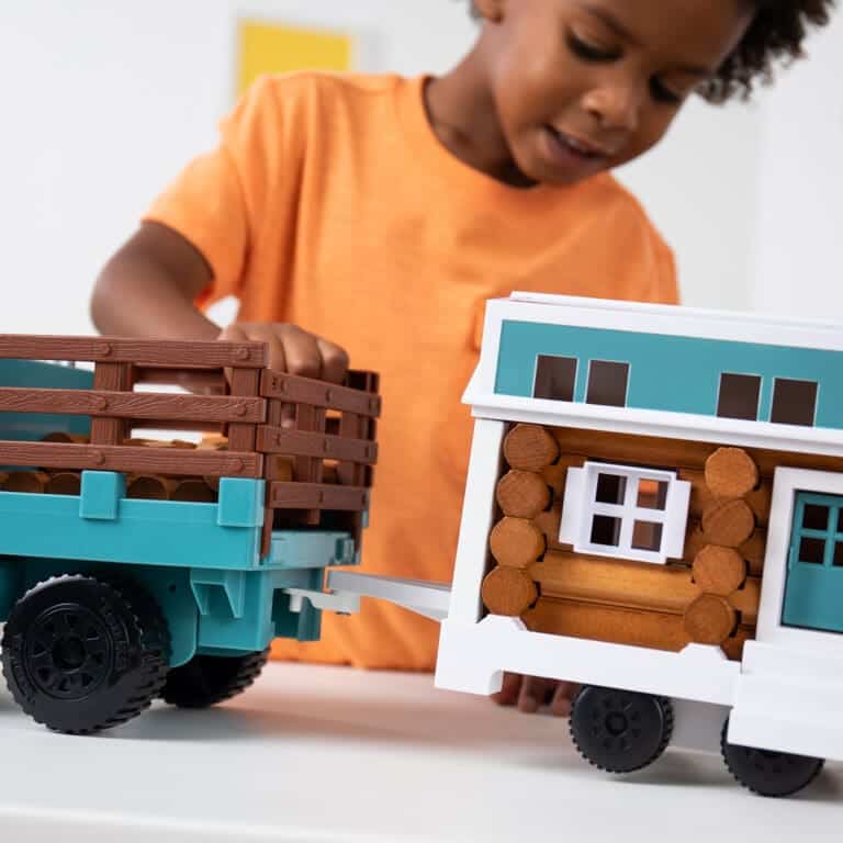 Kid with Lincoln Logs Tonka Tiny Home