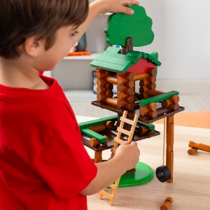 kid with lincoln logs treehouse