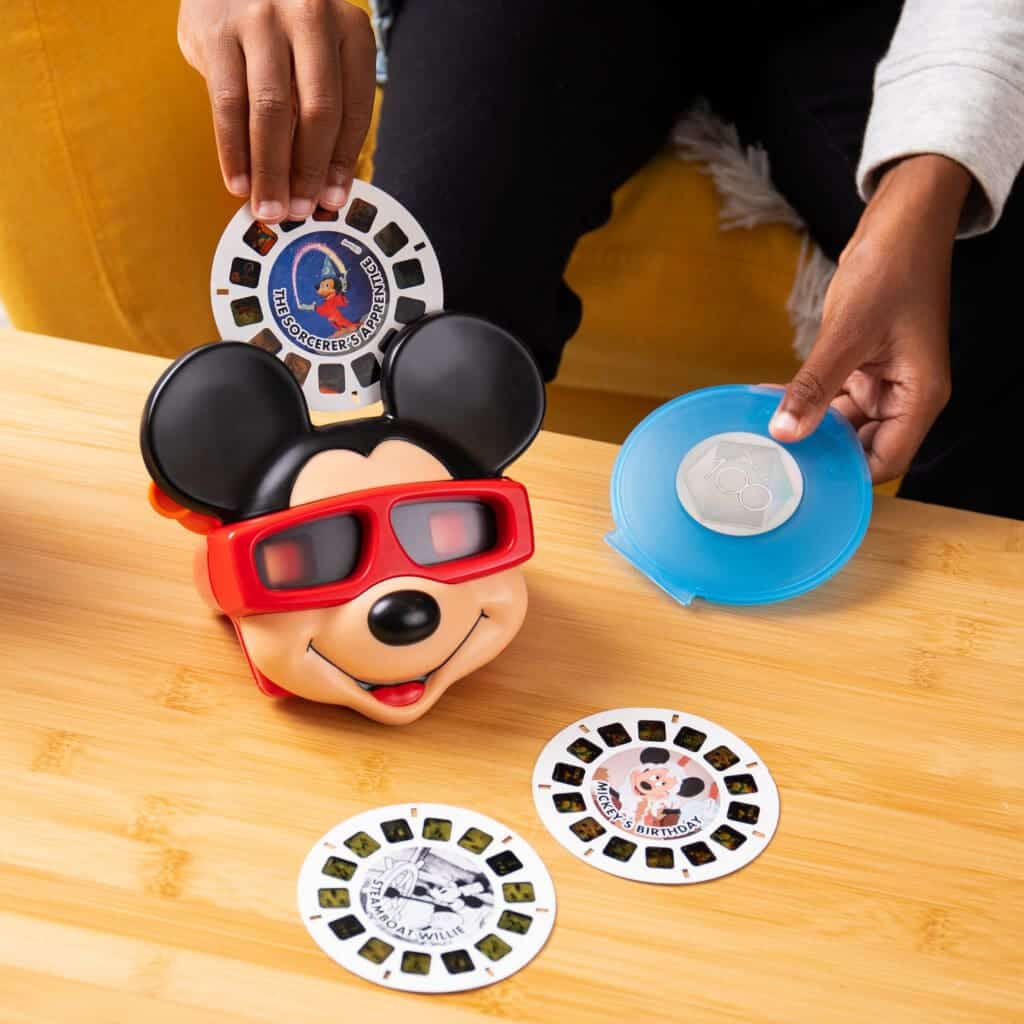 Young boy playing with View Master Mikey Mouse Deluxe Edition.