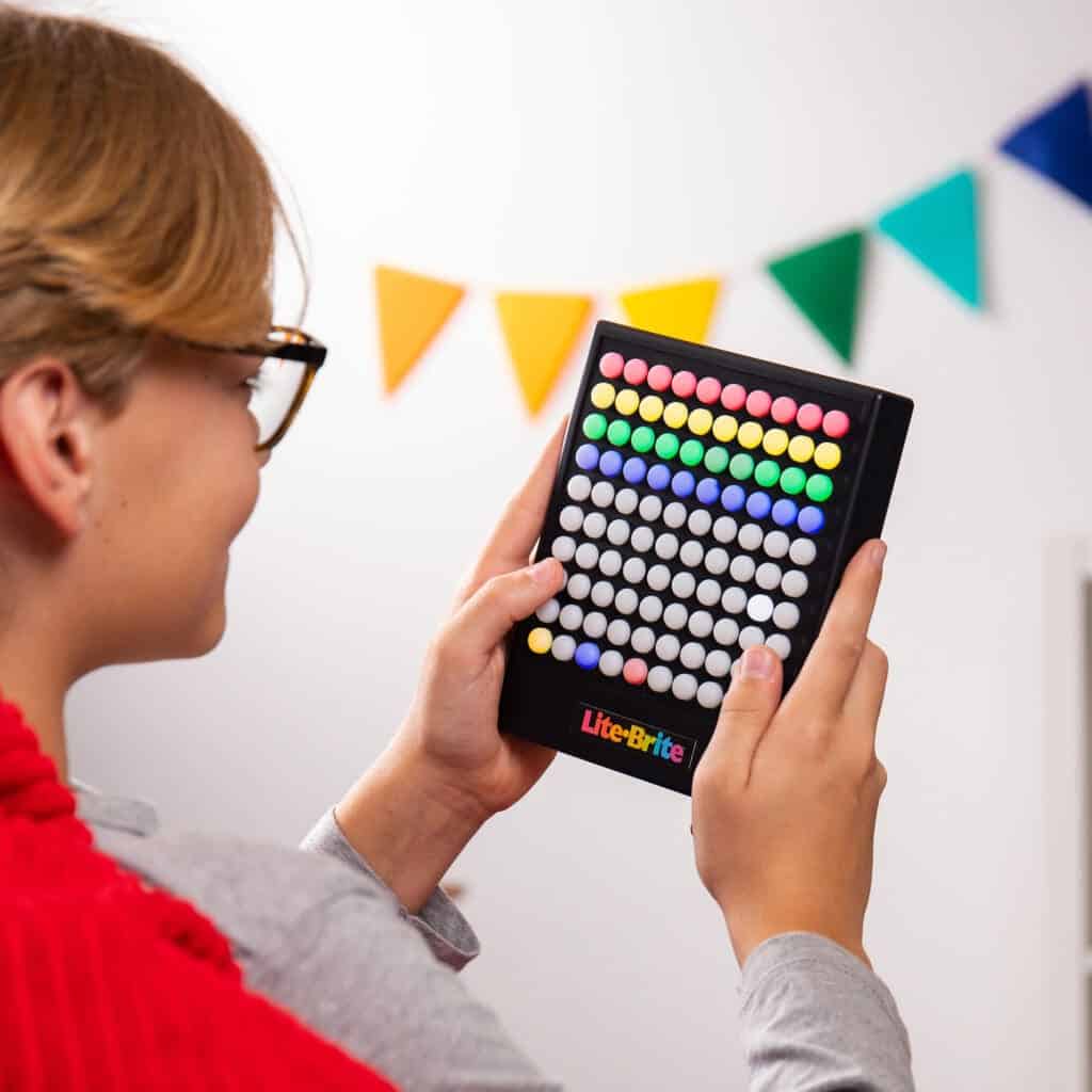 Young boy playing with Lite Brite Touch.