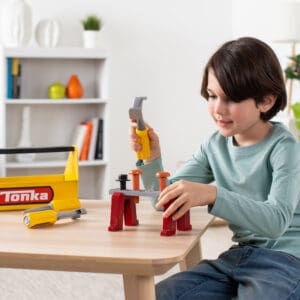 Young boy playing with Tonka Tough Toolbox Set.