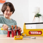 Young boy playing with Tonka Tough Toolbox Set.