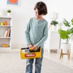 Young boy holding Tonka Tough Toolbox Set.
