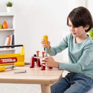 Young boy playing with Tonka Tough Toolbox Set.