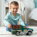 Young boy playing with Tonka Steel Classics Farm Truck.
