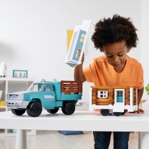 kid with Lincoln Logs Tonka Tiny Home