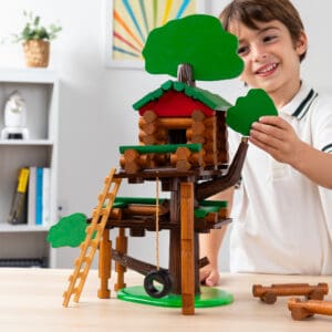 kid with lincoln logs treehouse