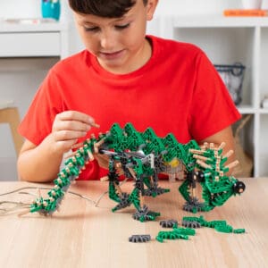 Young boy playing with Green K'nex K'nexosaurus Rex Motorized Building Toy.