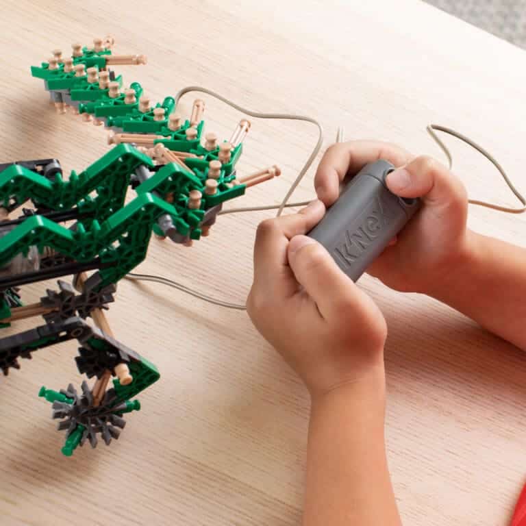 Boy with Knexosaurus rex, play feature