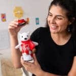 Young girl holding and playing with Coca-Cola Pop Can-polar bear.