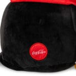 Close up of Coca-Cola logo on Trendy Penguin against white background.