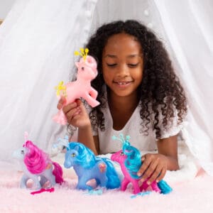 Young girl playing with My Little Pony Celestials assortment.