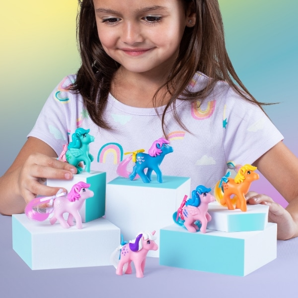 Young girl playing with My Little Pony Classics Figure Collector Pack