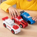 Young boy playing with Tonka Carrier Three Pack Sports Cars.