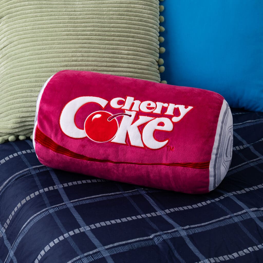 Coca-Cola Cherry Coke Novelty Plush Can on bed.