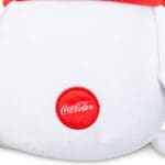 Close up of Coca-Cola logo on Coca-Cola Trendy Polar Bear against white background.
