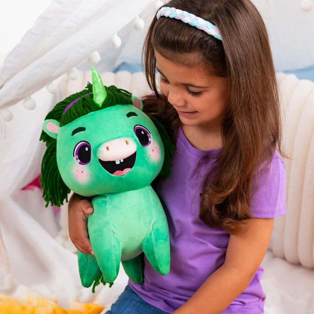 Not Quite Narwhal Juniper being held by young girl smiling.