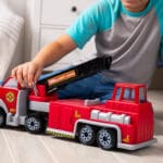 Tonka Hook N' Ladder Fire Truck being played with by young boy.