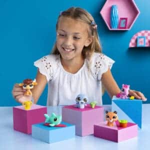 LPS Pet Surprise Singles on display with young girl playing with them.