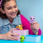 Young girl playing with LPS Pet Trio Wild Vibes Theme.