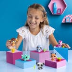LPS Pet Surprise Trio pets being played with by young girl.